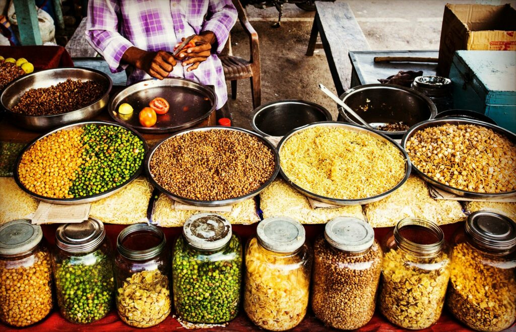 Colorful display of spices and legumes in a traditional Indian street market.