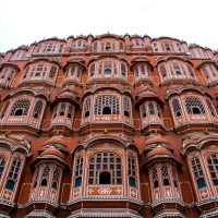 Low angle view of the iconic Hawa Mahal showcasing its elaborate facade in Jaipur, India.